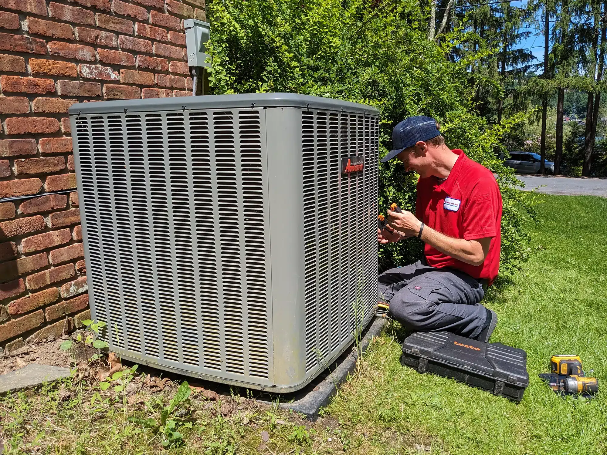 Mark Lindsay service technician smiling working outside of residential home.